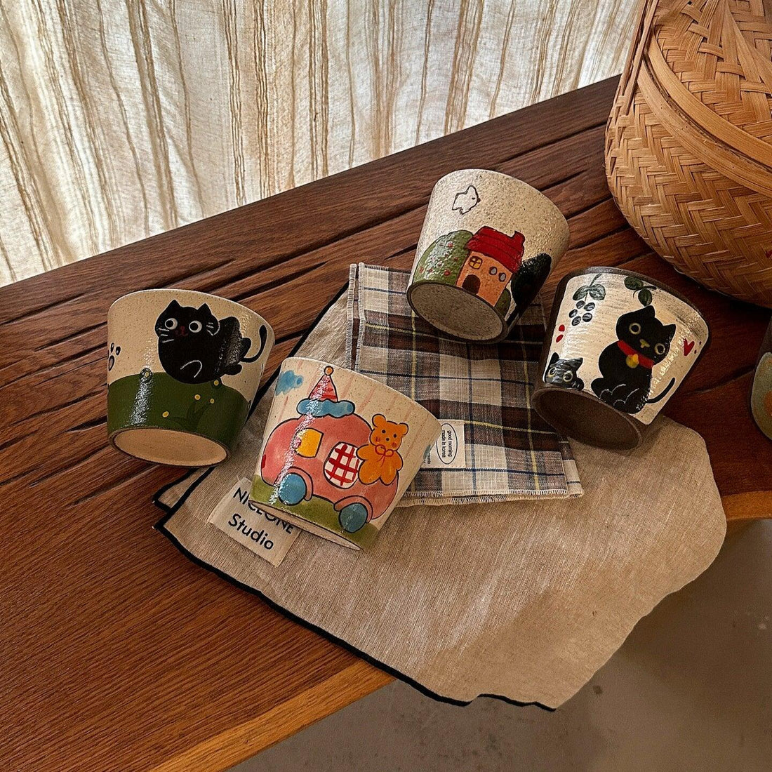 Hand-painted ceramic mugs with cute animal and floral designs, perfect for coffee or tea.