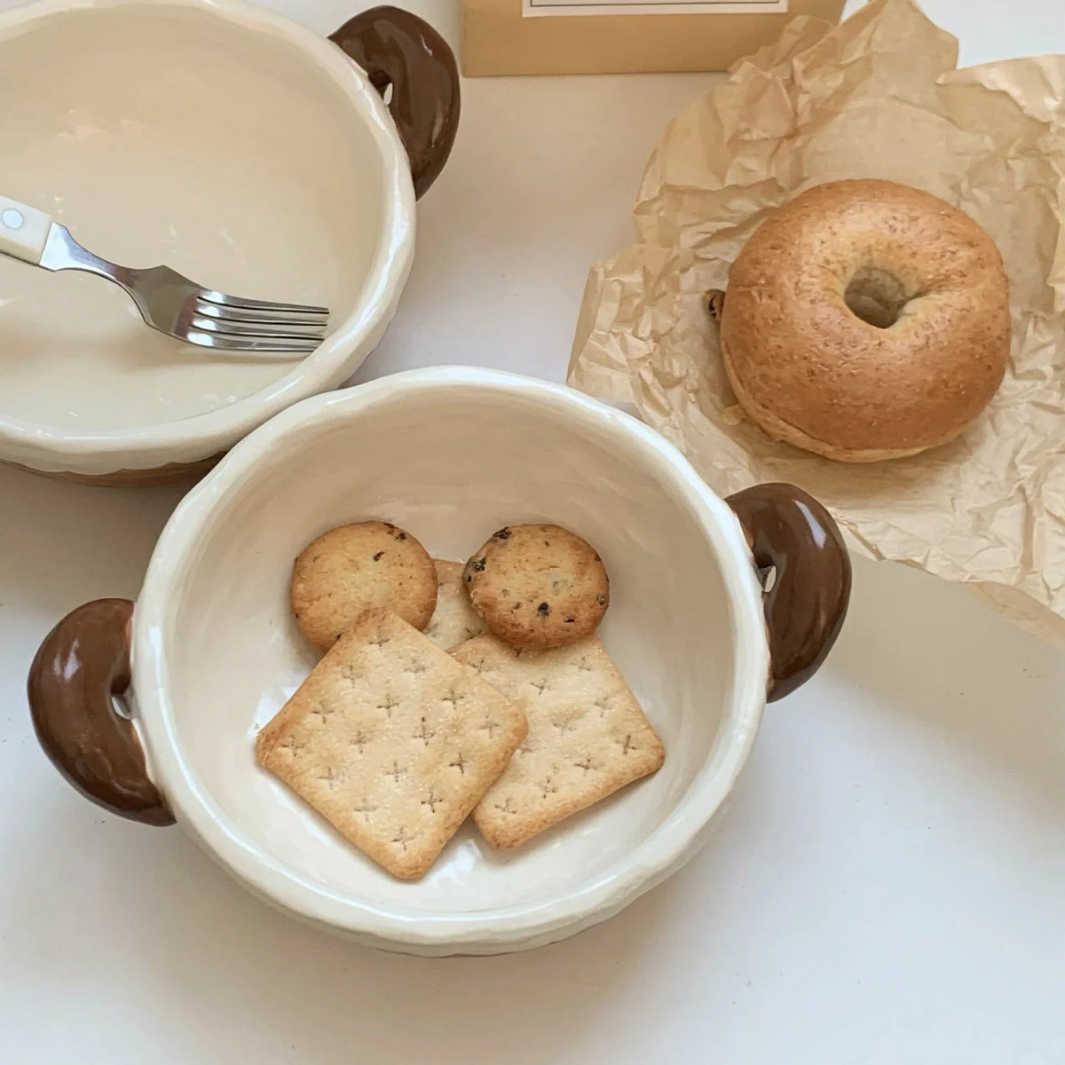 Handmade ceramic bowl with cookies and bagel, perfect for breakfast or snacks